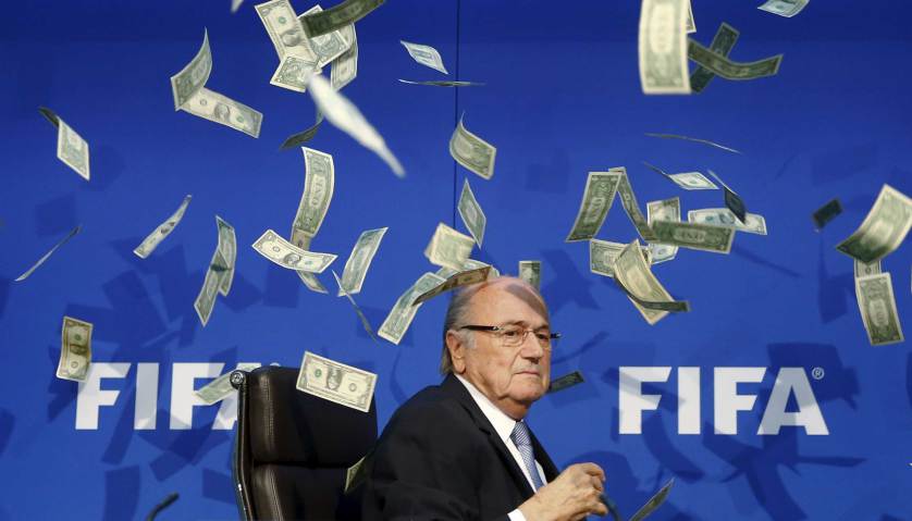 British comedian known as Lee Nelson (unseen) throws banknotes at FIFA President Sepp Blatter as he arrives for a news conference after the Extraordinary FIFA Executive Committee Meeting at the FIFA headquarters in Zurich, Switzerland July 20, 2015. World football's troubled governing body FIFA will vote for a new president, to replace Sepp Blatter, at a special congress to be held on February 26 in Zurich, the organisation said on Monday. REUTERS/Arnd Wiegmann TPX IMAGES OF THE DAY - RTX1L3H3