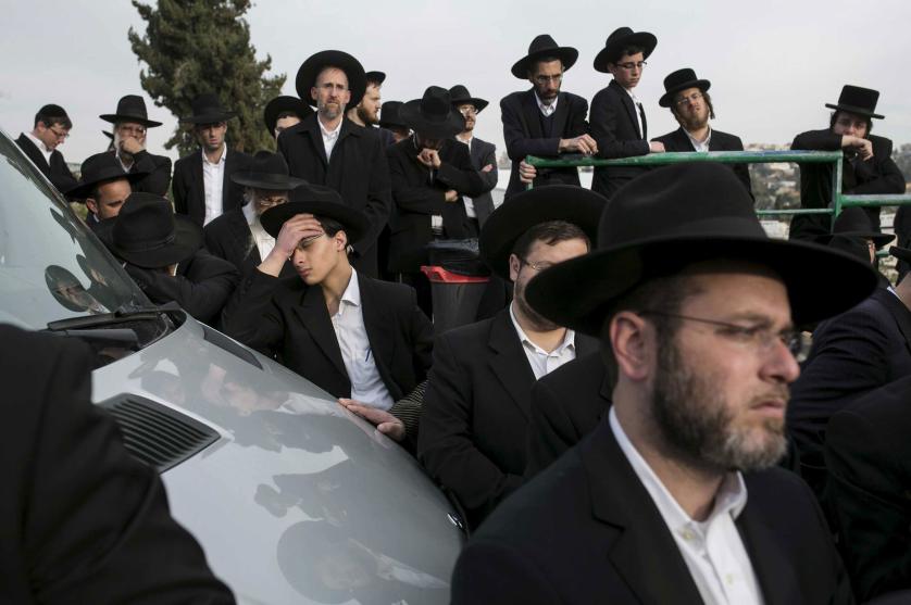 Mourners gather during the funeral service for seven children from the Sassoon family before their burial in Jerusalem March 23, 2015. The seven children from the Orthodox Jewish family died early on Saturday when flames ripped through their Brooklyn home in one of New York City's deadliest fires in years, officials said. Police have identified the children who died as Yaakob Sassoon, 5, Sara, 6, Moshe, 8, Yeshua, 10, Rivkah, 11, David, 12, and Eliane, 16. REUTERS/Baz Ratner