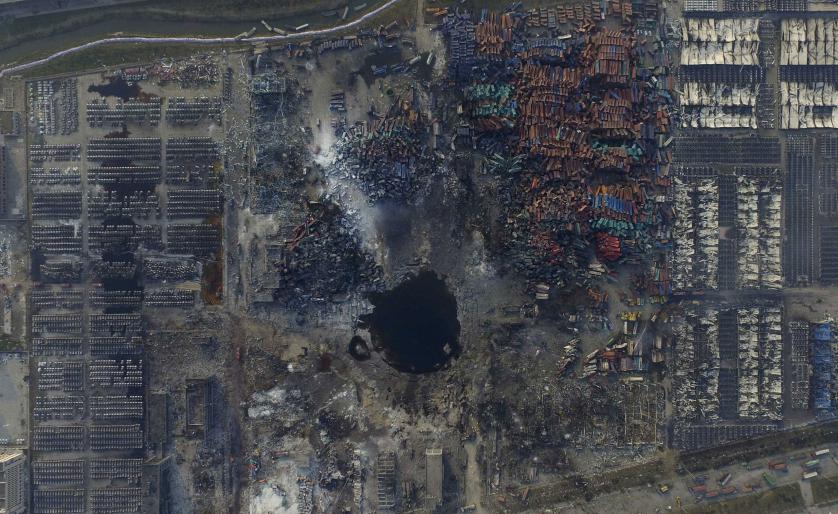 An aerial picture of the site of explosions at the Binhai new district, Tianjin, China, August 16, 2015. The explosions late last Wednesday in the world's 10th-busiest port in China's industrial northeast, forced the evacuation of thousands of people after toxic chemicals were detected in the air. More than 700 people were injured and another 70, mostly fire fighters, are still missing. The blasts devastated a large industrial site and nearby residential areas. Picture taken August 16, 2015. REUTERS/Stringer CHINA OUT. NO COMMERCIAL OR EDITORIAL SALES IN CHINA TPX IMAGES OF THE DAY