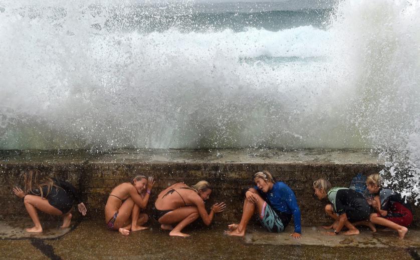 epa04986336 YEARENDER 2015 FEBRUARY Young people take shelter from big sea waves due to the Tropical Cyclone Marcia on the Gold Coast, Queensland, Australia, 20 February 2015. EPA/DAVE HUNT AUSTRALIA AND NEW ZEALAND OUT