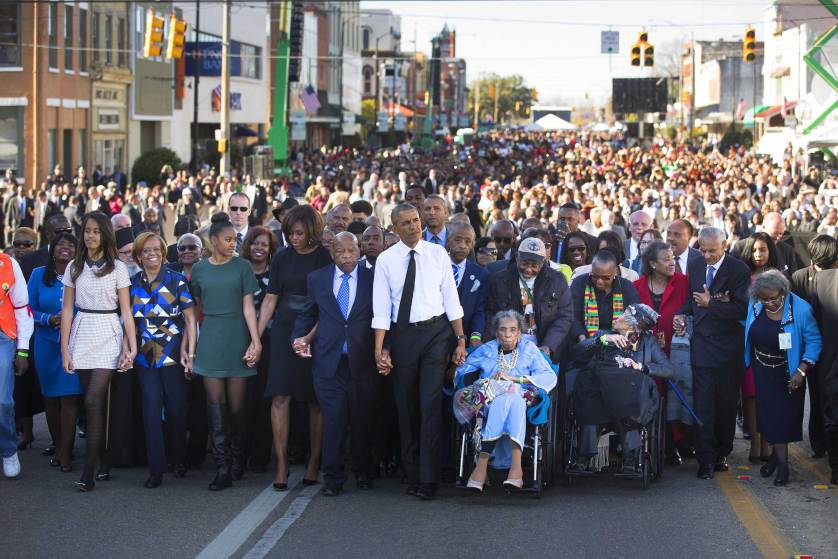 President Barack Obama, Amelia Boynton, right, Rep. John Lewis (D-Ga.) and the first family lead a march toward the Edmund Pettus bridge, 50 years to the day after ìBloody Sundayî in Selma, Ala., March 7, 2015. In an address, Obama rejected the notion that race relations have not improved in the years since -- as well as the notion that racism has been defeated. (Doug Mills/The New York Times)