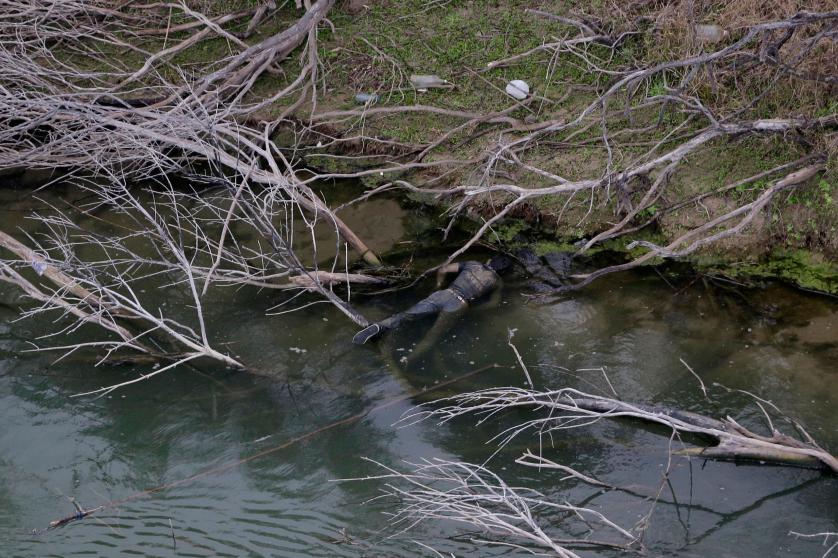 EDS NOTE: GRAPHIC CONTENT - A body discovered by the U.S. Customs and Border Protection Air and Marine while on patrol near the Texas-Mexico border floats in the Rio Grande, Tuesday, Feb. 24, 2015, in Rio Grande City, Texas. Five bodies were found at the scene. (AP Photo/Eric Gay)