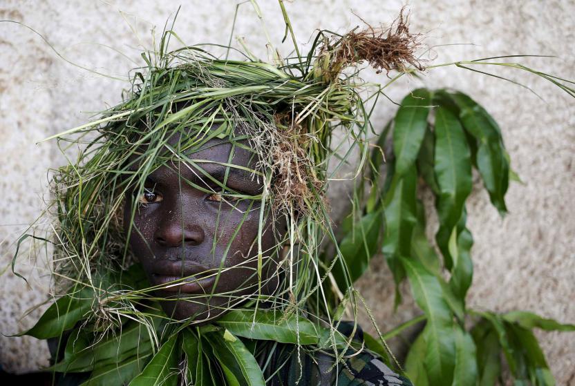 A protester wears grass around his face to obscure his identity during a protest against President Pierre Nkurunziza's decision to run for a third term, in Bujumbura, Burundi, May 11. 2015. East African leaders will hold a summit in Tanzania on May 13 aimed at breaking the political deadlock in Burundi and ensuring the country holds peaceful elections, Tanzania's presidency says. REUTERS/Goran Tomasevic TPX IMAGES OF THE DAY