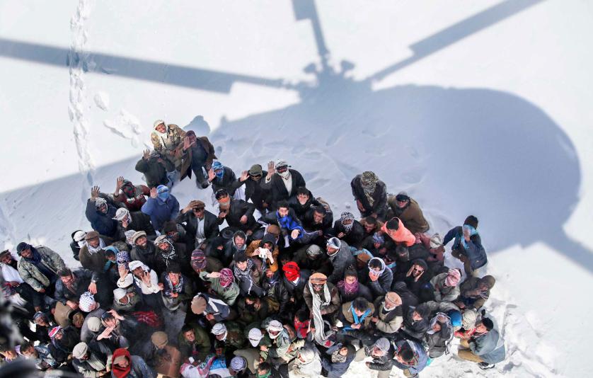 epaselect epa04641146 Survivors of an avalanche wait to receive relief goods distributed by an Army helicopter in Paryan district of Panjshir province, Afghanistan, 28 February 2015. According to local officials rescue teams restarted operations to find the victims of avalanches in Afghanistan's north-east as the total bodies found to at least 184 bodies in different areas of Panjsher province, with the total overall casualties at least 233 in various avalanche affected areas. EPA/HEDAYATULLAH AMID