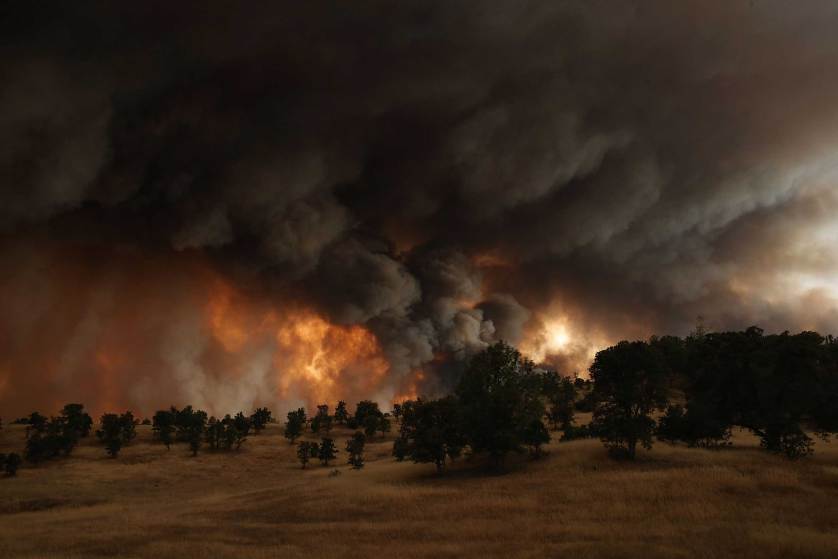 CLEARLAKE, CA - AUGUST 01: A large plume of smoke rises from the Rocky Fire on August 1, 2015 near Clearlake, California. Over 1,900 firefighters are battling the Rocky Fire that burned over 22,000 acres since it started on Wednesday afternoon. The fire is currently five percent contained and has destroyed at least 14 homes. (Photo by Justin Sullivan/Getty Images)