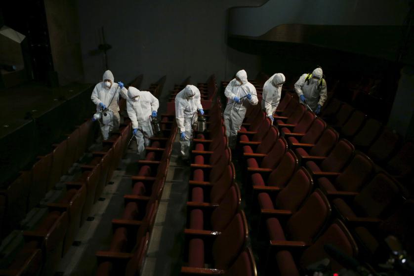 Employees from a disinfection service company sanitize the interior of a theater in Seoul, South Korea, June 18, 2015. An outbreak of Middle East Respiratory Syndrome (MERS) threatens to deal a blow to South Korea's economic recovery, Moody's Investors Service said on Thursday, as the Health Ministry reported three new cases, the lowest daily increase in 17 days. REUTERS/Kim Hong-Ji