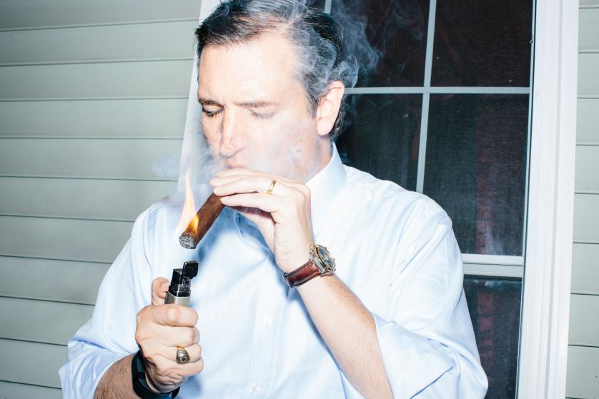 Texas senator and Republican presidential candidate Ted Cruz smokes a cigar after speaking at an event called "Smoke a cigar with Ted Cruz" at a house party at the home of Linda & Steven Goddu Salem, New Hampshire.