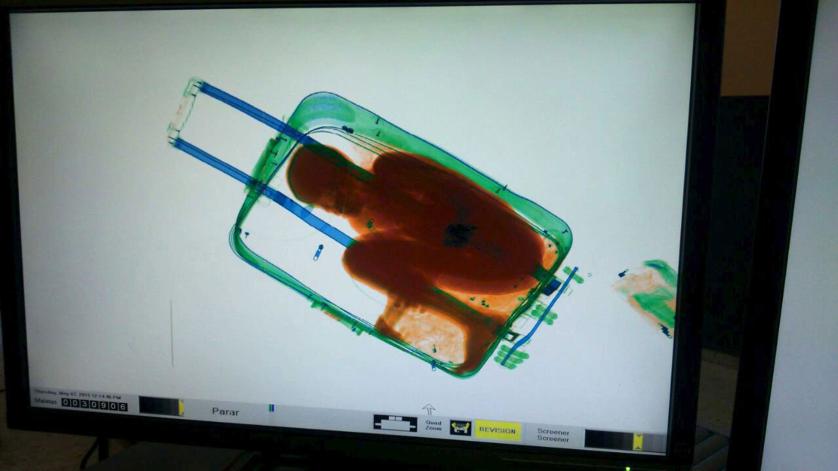 The figure of an eight-year-old boy is seen inside a suitcase on a Spanish civil guard scanner screen at the border between Morocco and Spain's north african enclave Ceuta, Spain in this handout photo released May 8, 2015. A 19-year-old woman was arrested May 7, 2015 for the attempted smuggling of the boy, who was checked by medics and handed over to juvenile prosecutors office, according to authorities. Picture taken May 7, 2015. REUTERS/MINISTERIO DEL INTERIOR/Handout via Reuters ATTENTION EDITORS - THIS PICTURE WAS PROVIDED BY A THIRD PARTY. REUTERS IS UNABLE TO INDEPENDENTLY VERIFY THE AUTHENTICITY, CONTENT, LOCATION OR DATE OF THIS IMAGE. NO SALES. NO ARCHIVES. FOR EDITORIAL USE ONLY. NOT FOR SALE FOR MARKETING OR ADVERTISING CAMPAIGNS. THIS PICTURE IS DISTRIBUTED EXACTLY AS RECEIVED BY REUTERS, AS A SERVICE TO CLIENTS. NO COMMERCIAL USE. TPX IMAGES OF THE DAY