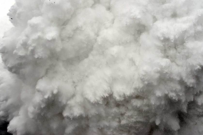 In this photograph taken on April 25, 2015, a cloud of snow and debris triggered by an earthquake flies towards Everest Base Camp, moments ahead of flattening part of the camp in the Himalayas. Rescuers in Nepal are searching frantically for survivors of a huge quake on April 25, that killed nearly 2,000, digging through rubble in the devastated capital Kathmandu and airlifting victims of an avalanche at Everest base camp. AFP PHOTO/ROBERTO SCHMIDTROBERTO SCHMIDT/AFP/Getty Images