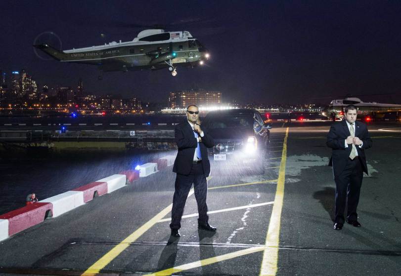 TOPSHOTS US Secret Service Agents stand guard as Marine One, with US President Barack Obama board, prepares to land at the Downtown Manhattan Heliport in, New York City, on November 2, 2015. Obama is traveling to attend Democratic fundraisers. AFP PHOTO / SAUL LOEBSAUL LOEB/AFP/Getty Images