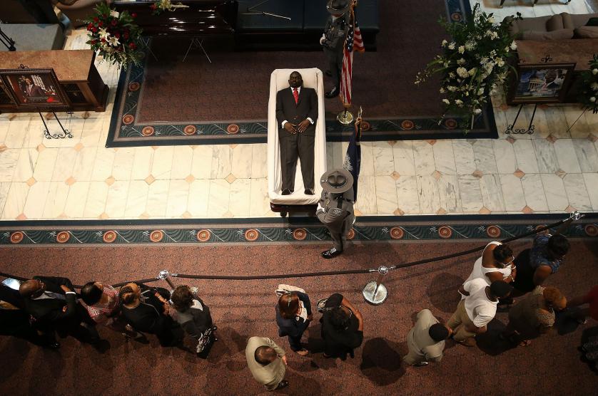 COLUMBIA, SC - JUNE 24: Visitors pay their respects during an open viewing for Rev. Clementa Pinckney at the South Carolina State House June 24, 2015 in Columbia, South Carolina. Pinckney was one of nine people killed during a Bible study inside Emanuel AME church in Charleston. U.S. President Barack Obama and Vice President Joe Biden are expected to attend the funeral which is set for Friday June 26 at the TD Arena. (Photo by Win McNamee/Getty Images) *** BESTPIX ***